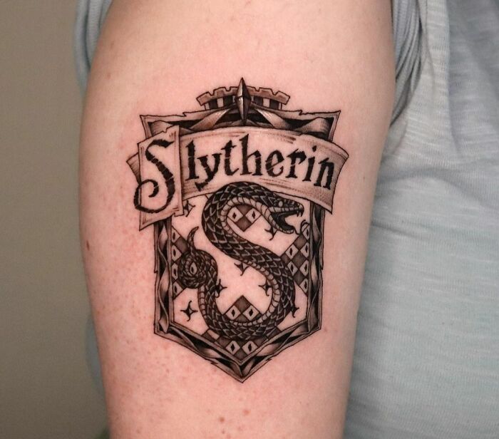 Slytherin tattoo with serpent design on arm, perfect for Harry Potter fans.