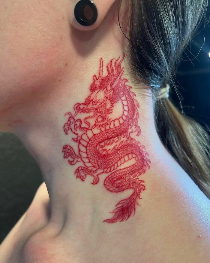 Red ink dragon tattoo design on the neck, showcasing intricate details and artistry.