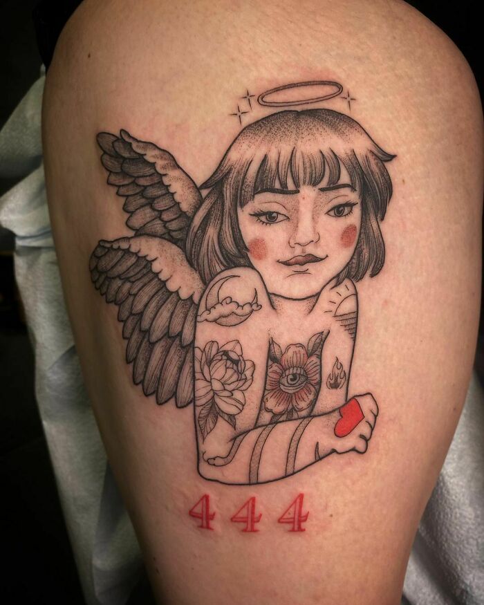 Angel-themed design with red ink tattoo featuring the number 444, highlighting red ink tattoo creativity.