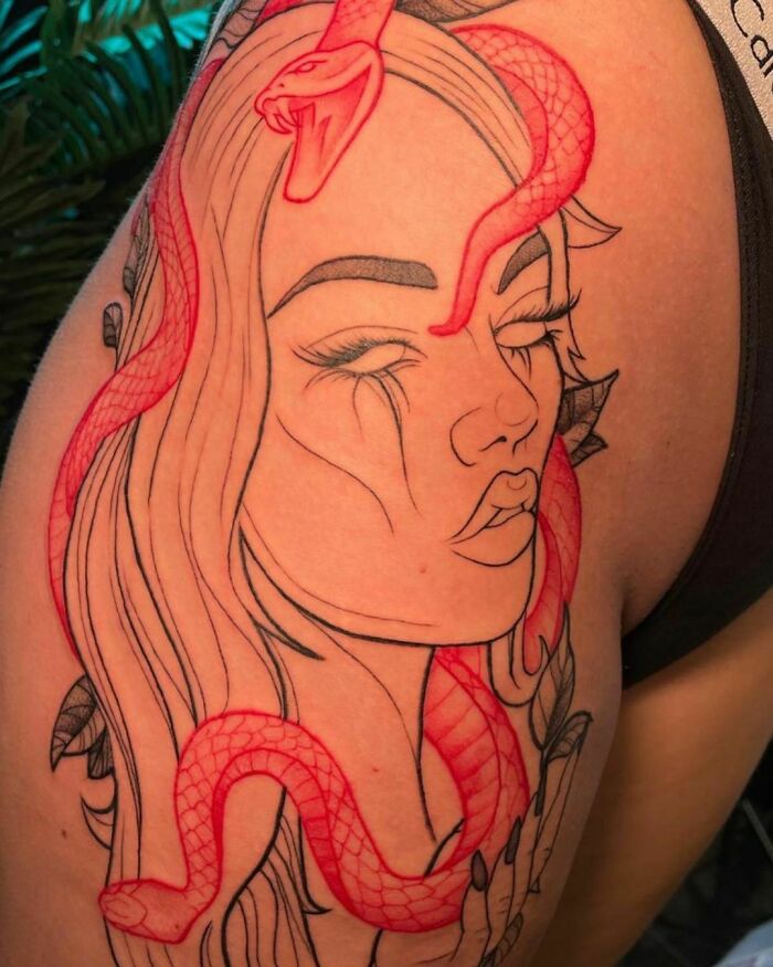 Red ink tattoo design of a woman's face with a snake on the shoulder.