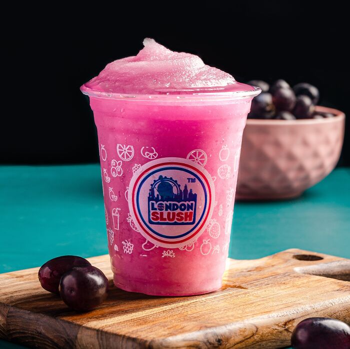 Slushy In A Plastic Cup On A Wooden Cutting Board 