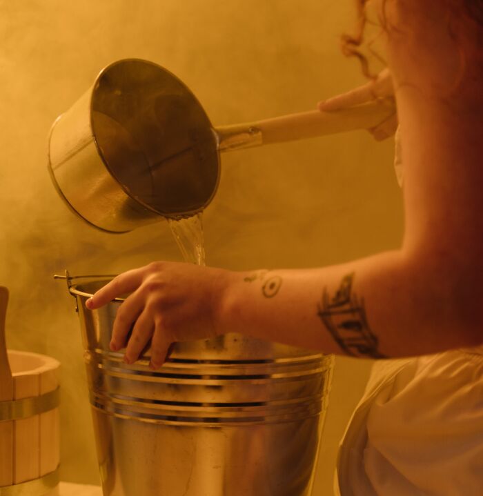 Pouring Water In Sauna 