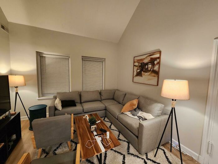 Cozy living room with a gray sectional, modern decor, featuring warm lighting for creative inspiration.