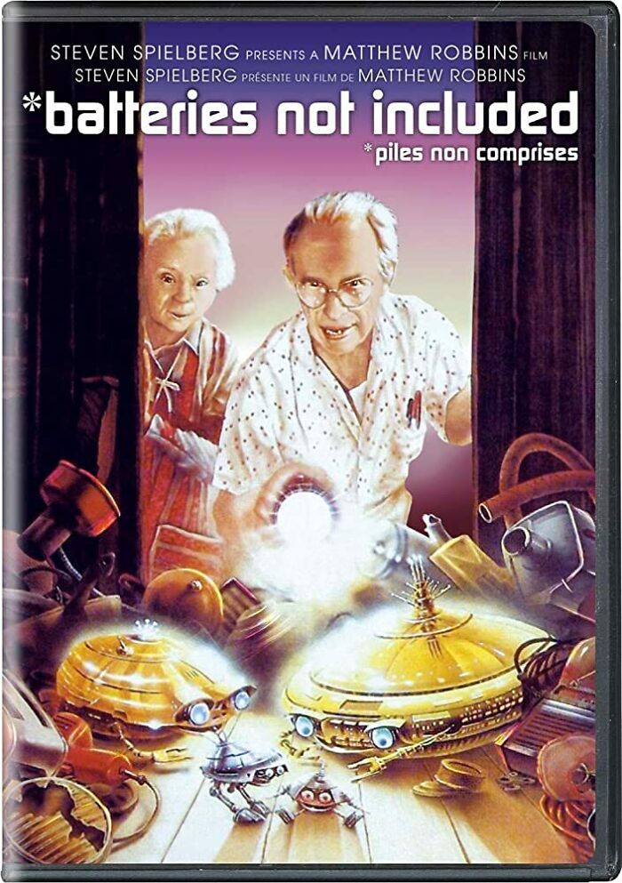 DVD cover of "Batteries Not Included" showing two characters looking at small robotic creatures, representing old generation humor.
