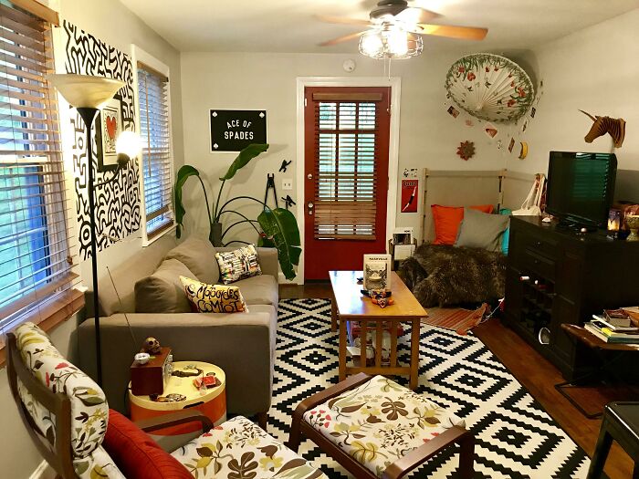 Cozy living room with creative decoration ideas, featuring patterned rug, colorful pillows, and a vibrant wall art.