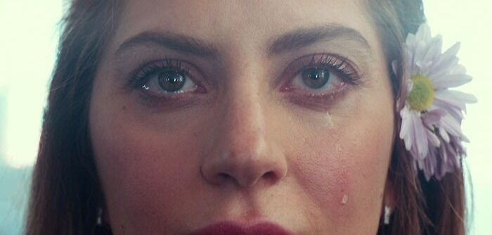 Ally crying with flower behind her ear