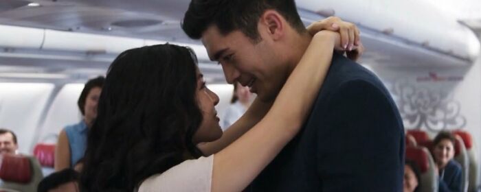 Nick and Rachel hugging on the plane 