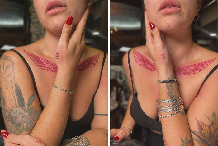 Red ink tattoo of wings on a woman's chest, showcasing intricate design, with floral arm tattoo and silver bracelets.