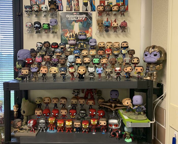 Creative decoration ideas featuring a diverse collection of superhero figurines displayed on a shelf.