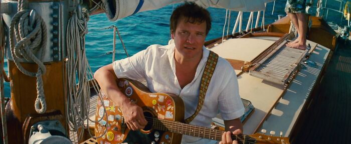 Harry playing guitar on the boat 