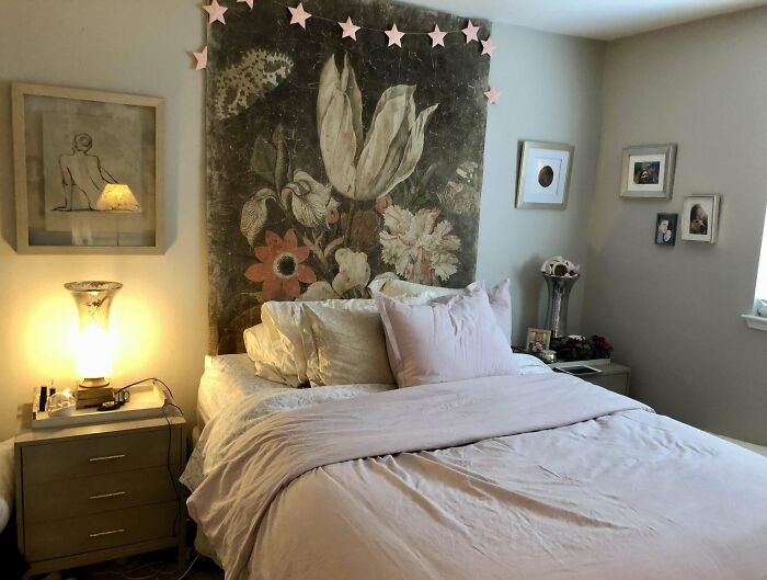 Cozy bedroom with floral tapestry, soft bedding, and ambient lighting, showcasing stylish home decoration ideas.