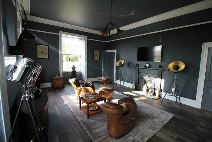 Stylish living room with vintage decor and dark walls for home decoration inspiration.