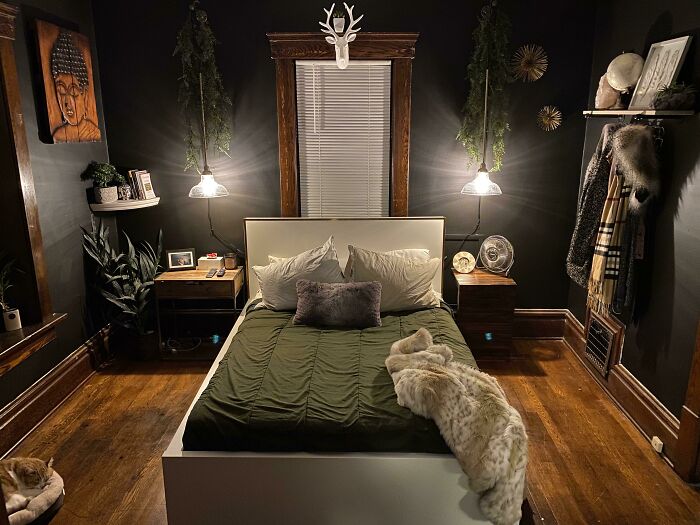 Cozy bedroom design with green bedding, plants, and artwork for creative decoration inspiration.