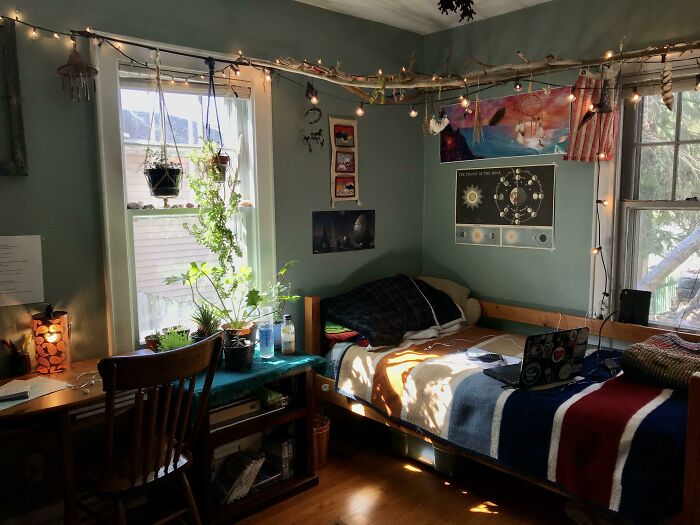 Cozy bedroom with string lights, plants, and wall art for home decoration ideas.