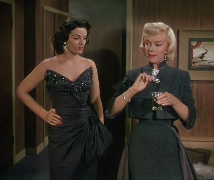 Two women in elegant dresses, classic iconic best friend duo in a stylish setting.