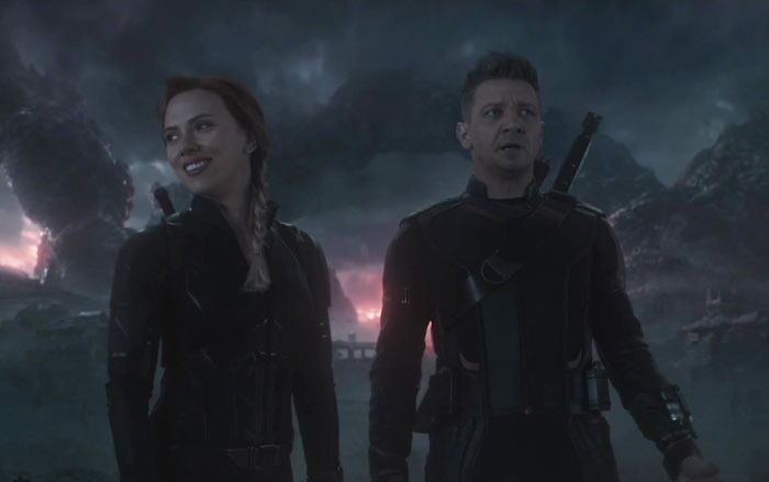 Two iconic best friend duos in a dramatic, cloudy setting, wearing black stealth suits.