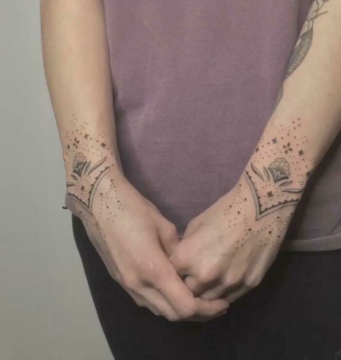 Stylish wrist tattoos with intricate designs, featuring stars and geometric patterns.