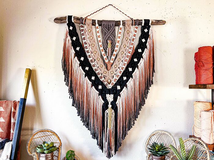Creative decoration idea featuring a colorful macrame wall hanging with intricate patterns and fringe details.