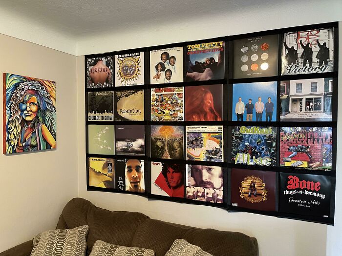 Creative decoration idea featuring a wall-mounted display of vinyl record covers in a cozy room with a colorful painting.