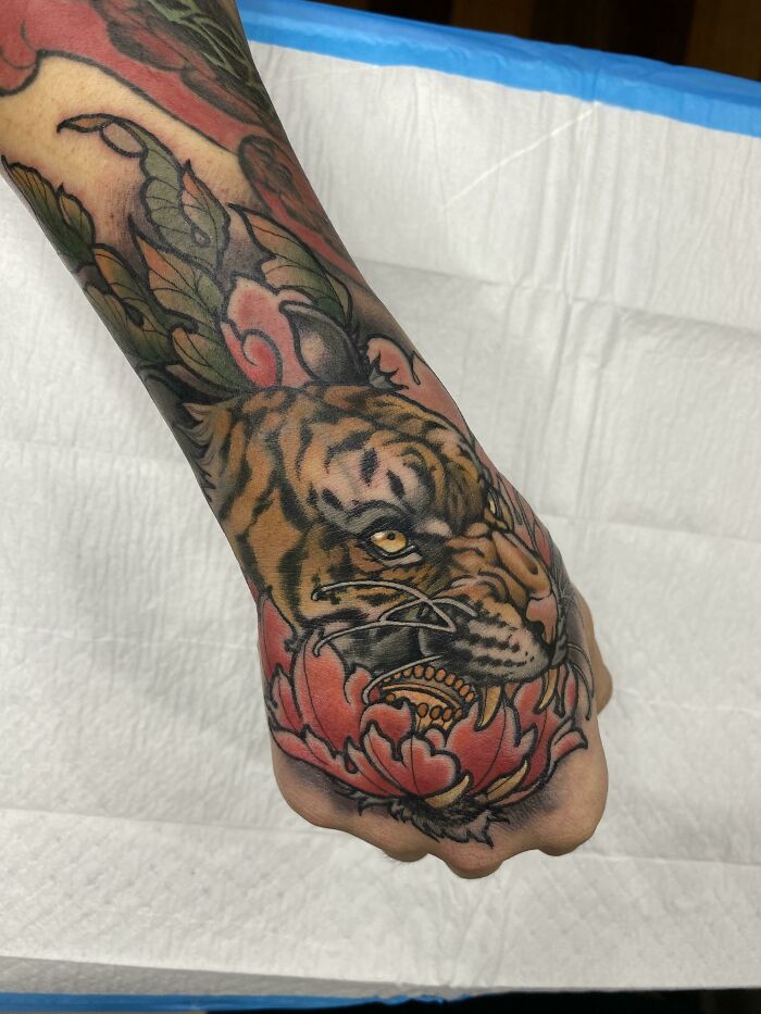 Tiger wrist tattoo design with vibrant colors and intricate details.