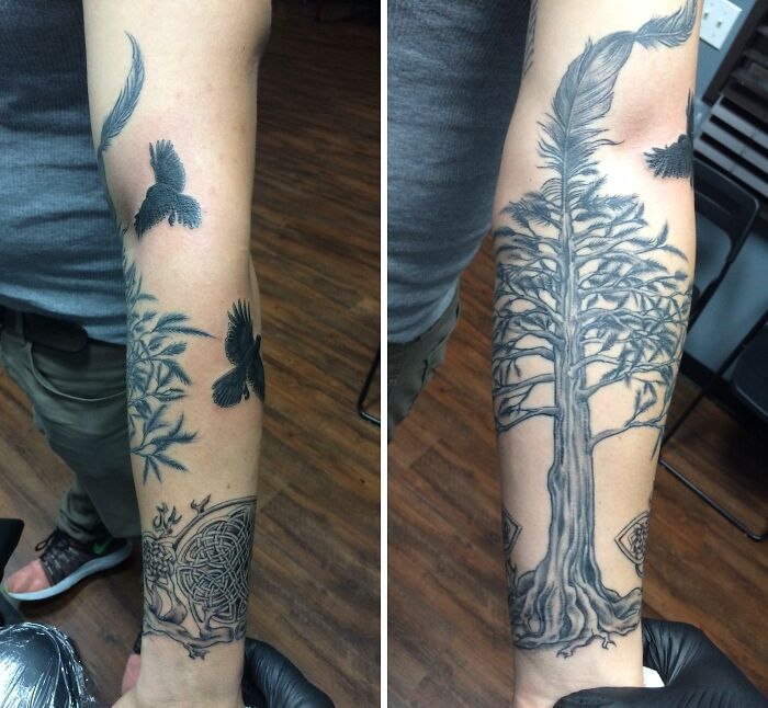 Intricate wrist tattoos featuring birds and a tree design.