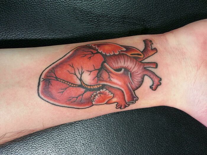 Realistic heart wrist tattoo design making a bold statement.
