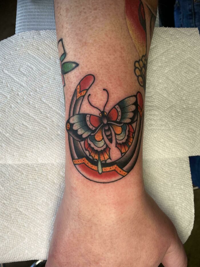 Colorful butterfly wrist tattoo design, highlighting a timeless accessory.