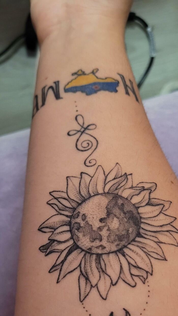 Sunflower and moon wrist tattoo design with intricate details.