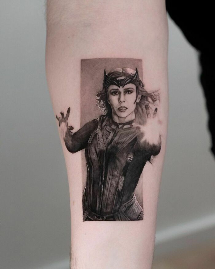Marvel tattoo featuring a powerful female character Wanda Maximoff casting a spell on the forearm.
