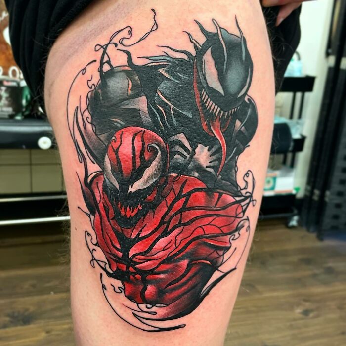 Colorful Marvel tattoo featuring Venom and Carnage on a person's thigh.