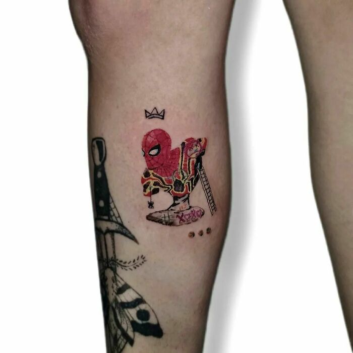 Marvel tattoo featuring Spider-Man in vibrant colors on a leg, showcasing artistic detail and creativity.