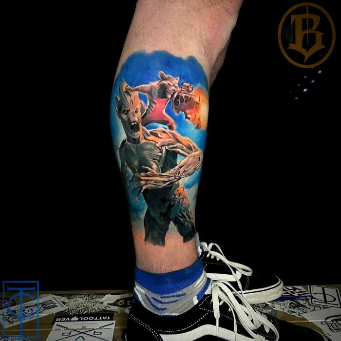 Marvel tattoo featuring Groot and Rocket Raccoon on a person's leg, showcasing vivid colors and dynamic design.