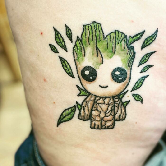 Cute Marvel tattoo of Groot character with leaves, symbolizing a playful and nature-inspired design.