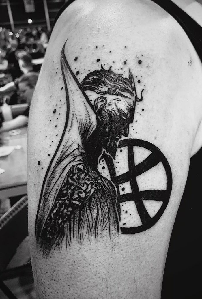 Marvel tattoo of Doctor Strange on a person's arm, features intricate black ink detailing.