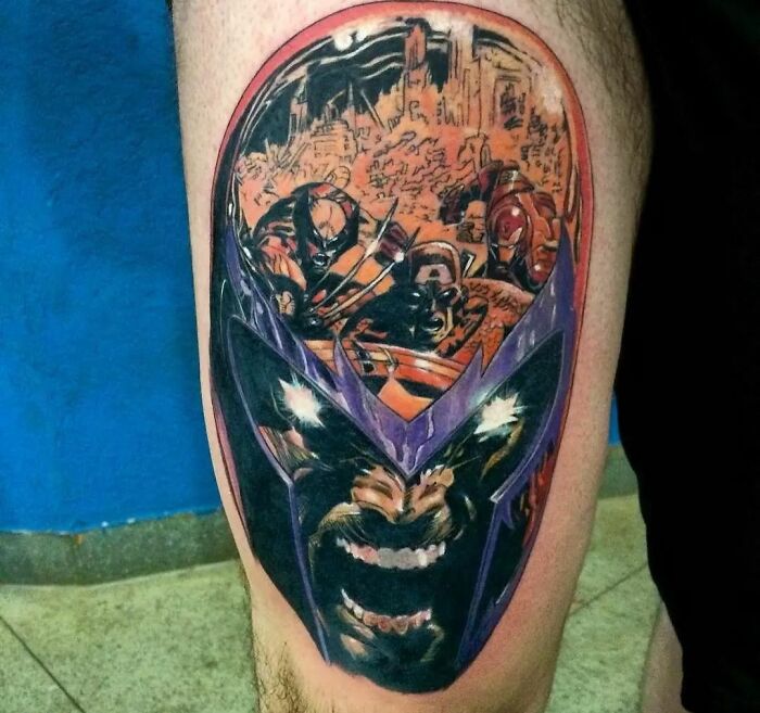 Marvel tattoo featuring a fierce superhero Magneto portrait on calf, showcasing vibrant colors and dynamic design.
