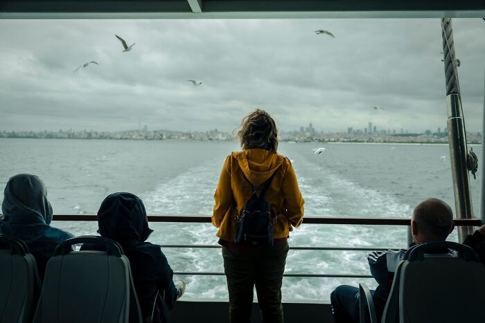 woman standing in the riding boat