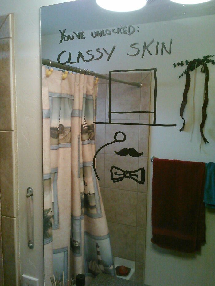 Person taking a picture of a message on a mirror 