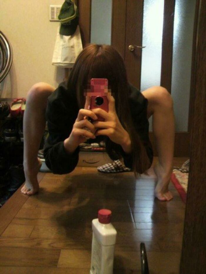 Scary mirror picture of a woman standing like a spider 