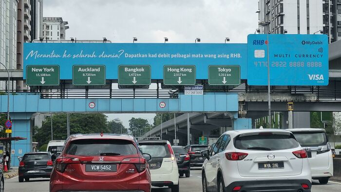 Ad On The Road That Imitates Real Street Signs