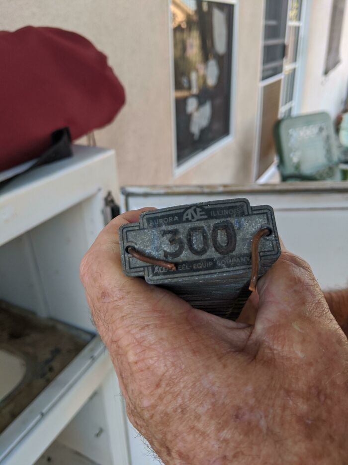 1 Through 300 Metal Tags Found In An Old (1920s)ice Box. The Copper Wires Are There Just To Hold The Whole Stack Together