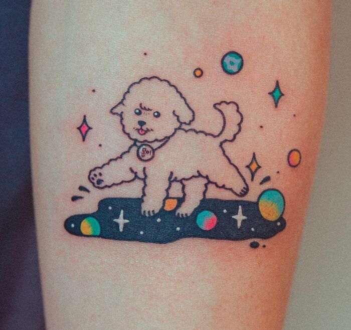 Cute dog in a space tattoo with planets and stars, perfect for astrology fans.