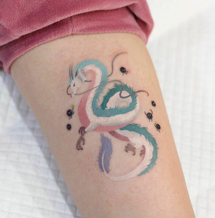 Color tattoo by Saegeem featuring a pastel dragon design surrounded by small black insects.