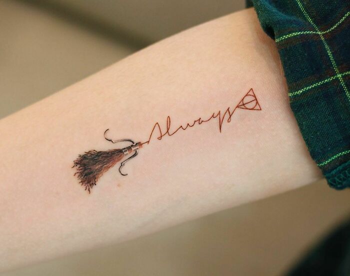 Color tattoo of a broomstick and the word "Always" with a symbol, designed by Saegeem.