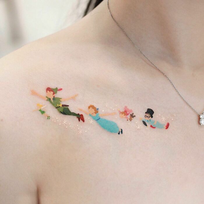 Color tattoo of flying fairy-tale characters on shoulder, showcasing exceptional artistry.