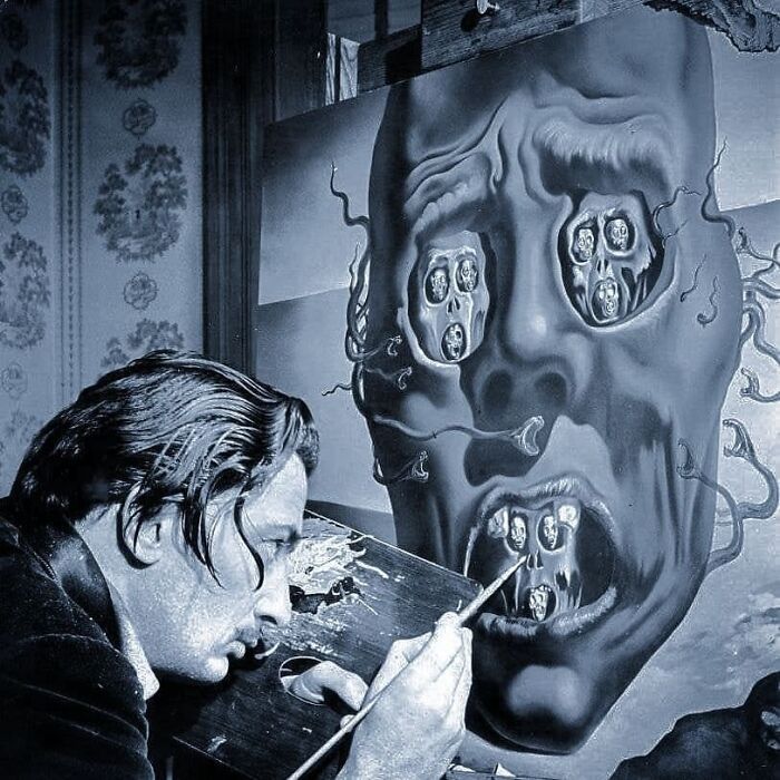 Artist painting a surreal face with distorted features in an important historical photo that might change your perspective on things.