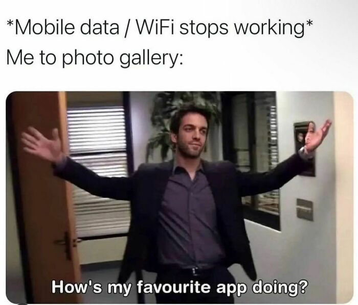 A person humorously gesturing with open arms in an office, illustrating spicy memes about mobile data issues.