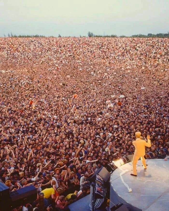 Massive crowd gathered at an outdoor concert, showcasing one of the important historical photos capturing large public events.