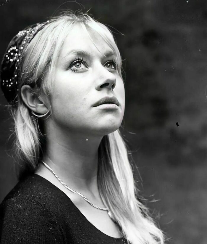 Black and white portrait of a young woman looking upward, an important historical photo capturing a reflective moment.