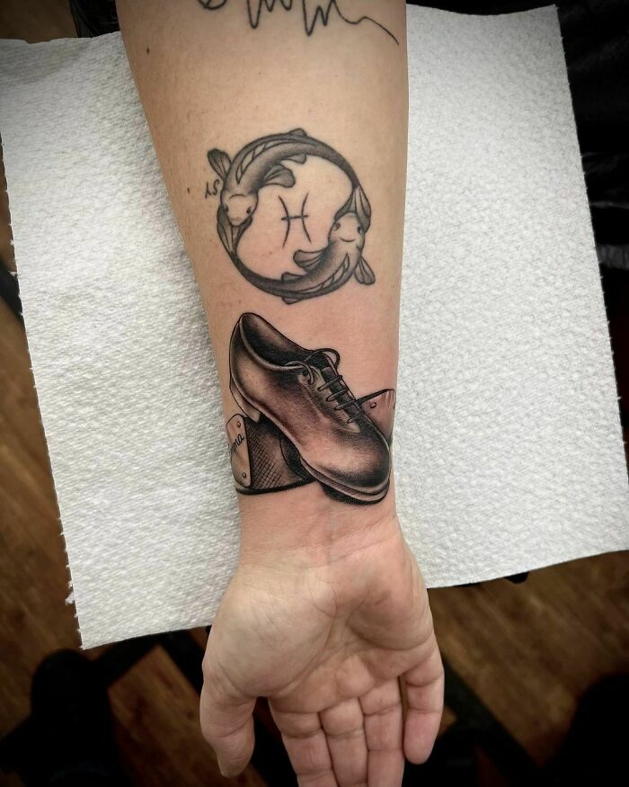 Wrist tattoo featuring a Pisces symbol with koi fish and a realistic shoe design for unique accessory.