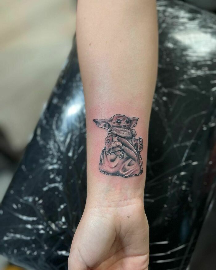 Wrist tattoo featuring a small character design, showcasing unique tattoo ideas and making a visual statement.